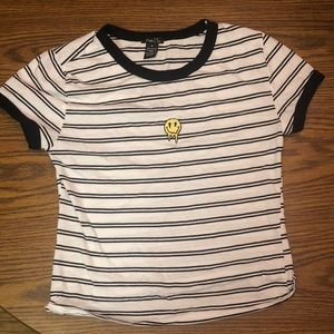 A striped Women’s (M) cropped t-shirt with the print of a smiley face on front.